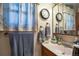 Cozy bathroom with a vanity, sink, mirror, floral curtains and soft lighting at 2015 Arapahoe St, Golden, CO 80401