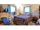Simple bedroom with a comfortable bed, dresser, fan, and window with natural light at 2015 Arapahoe St, Golden, CO 80401