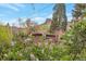Brick house surrounded by flowering bushes, lush trees, and scenic mountain views at 2015 Arapahoe St, Golden, CO 80401