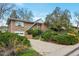 Charming brick home with an attached garage, mature landscaping, and a well-maintained front yard at 2015 Arapahoe St, Golden, CO 80401
