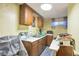 Utility kitchen with sink, cabinets, microwave, table, and accessories at 2015 Arapahoe St, Golden, CO 80401