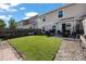 Spacious backyard with patio, grass, and wood fence at 6005 Turnstone Pl, Castle Rock, CO 80104