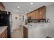 Kitchen with light-brown cabinets and a breakfast bar at 6005 Turnstone Pl, Castle Rock, CO 80104