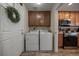 Convenient laundry room with washer, dryer, and cabinets at 6005 Turnstone Pl, Castle Rock, CO 80104