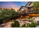 Beautiful backyard with a two-level deck, lush landscaping, and a charming fire pit area at 600 Cascade Dr, Golden, CO 80403