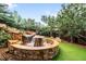 Backyard rock waterfall feature with manicured lawn and patio seating at 600 Cascade Dr, Golden, CO 80403