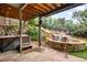 Covered outdoor patio featuring a hot tub and stone waterfall at 600 Cascade Dr, Golden, CO 80403