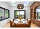 Bright dining area features a stylish light fixture, skylights, and a door leading to the deck at 600 Cascade Dr, Golden, CO 80403