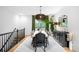 Modern dining room features a rustic table, stylish lighting, and large window with leafy green views at 600 Cascade Dr, Golden, CO 80403