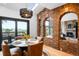 Stylish dining room showcases a brick archway, skylights, and doors opening to outdoor deck at 600 Cascade Dr, Golden, CO 80403