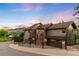 Stunning two-story home features a stone turret, fenced yard, and beautiful mountain views at sunset at 600 Cascade Dr, Golden, CO 80403