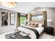 Spacious main bedroom with vaulted ceilings, windows with green views and a cozy rug at 600 Cascade Dr, Golden, CO 80403