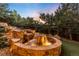 Backyard water feature with rocks and lush foliage in a landscaped yard at 600 Cascade Dr, Golden, CO 80403