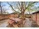 Inviting backyard featuring a dining set under a mature shade tree at 2731 S Logan St, Englewood, CO 80113