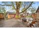 Private backyard patio with a mature tree, fire pit, detached garage and outdoor seating perfect for relaxing at 2731 S Logan St, Englewood, CO 80113