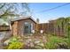 Charming backyard with stone patio, dining set, and lush garden space at 2731 S Logan St, Englewood, CO 80113