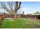 Beautiful yard with a detached garage, pergola and an outdoor seating area, all surrounded by a wooden fence at 2731 S Logan St, Englewood, CO 80113