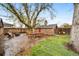Large backyard with mature trees, outdoor seating, and brick structure at 2731 S Logan St, Englewood, CO 80113