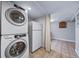 Basement with a washer/dryer set, refrigerator, and tiled floor at 2731 S Logan St, Englewood, CO 80113