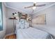 Cozy bedroom featuring hardwood floors, modern sconces, and natural light from a window at 2731 S Logan St, Englewood, CO 80113