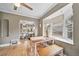 Cozy dining area featuring bench seating, a large bay window, and refinished hardwood flooring at 2731 S Logan St, Englewood, CO 80113