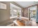 Inviting dining area with exposed brick accent wall, bay window, and charming bench seating at 2731 S Logan St, Englewood, CO 80113
