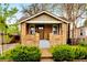Charming brick home with a well-manicured front yard and inviting porch at 2731 S Logan St, Englewood, CO 80113