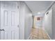 Basement hallway featuring tiled floors and freshly painted walls, leading to another room at 2731 S Logan St, Englewood, CO 80113