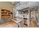 Bright kitchen featuring quartz countertops, stainless steel dishwasher, and wood floating shelves at 2731 S Logan St, Englewood, CO 80113