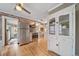 Bright kitchen featuring exposed brick, stainless steel appliances, and refinished hardwood floors at 2731 S Logan St, Englewood, CO 80113