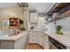 Charming kitchen with white cabinets, quartz countertops, subway tile backsplash, and wood floating shelves at 2731 S Logan St, Englewood, CO 80113