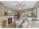 Comfortable living room with a decorative fireplace, hardwood floors, and neutral color scheme at 2731 S Logan St, Englewood, CO 80113