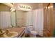 Well-lit bathroom featuring a large mirror, neutral tile, and a classic vanity at 9946 Wyecliff Dr, Highlands Ranch, CO 80126