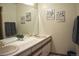 Bathroom featuring double sinks, large mirror, and clean white counter tops at 9946 Wyecliff Dr, Highlands Ranch, CO 80126