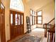 Bright foyer with wood and tile floors, arched transom windows, and staircase at 9946 Wyecliff Dr, Highlands Ranch, CO 80126