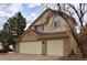 Two-story home with a two-car garage, and light tan siding with a brick facade at 9946 Wyecliff Dr, Highlands Ranch, CO 80126