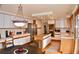 Spacious kitchen features white cabinets and a kitchen island with cooktop at 9946 Wyecliff Dr, Highlands Ranch, CO 80126