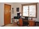 Home office showcasing a wooden desk, natural light from the window, and functional storage solutions at 9946 Wyecliff Dr, Highlands Ranch, CO 80126