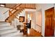 Carpeted staircase with wood banister and railing leading to the upper level at 9946 Wyecliff Dr, Highlands Ranch, CO 80126