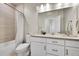 Bright bathroom with a double vanity and a tub/shower combo with modern finishes at 1575 W 68Th Ave, Denver, CO 80221