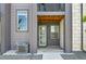 Charming townhome entrance featuring a stylish door with glass inserts and a welcoming covered porch at 1575 W 68Th Ave, Denver, CO 80221