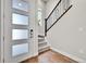 Bright entryway featuring wood floors, modern staircase, and stylish front door with glass panels at 1575 W 68Th Ave, Denver, CO 80221