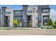 Stylish townhome with a modern facade, multiple windows, and well-maintained landscaping at 1575 W 68Th Ave, Denver, CO 80221
