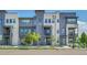 Modern townhome exterior with a combination of gray siding and stone accents, plus manicured landscaping at 1575 W 68Th Ave, Denver, CO 80221