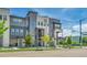 Contemporary townhome exterior showcasing balconies, ample windows, and fresh green landscaping at 1575 W 68Th Ave, Denver, CO 80221