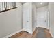 Inviting home hallway featuring wood floors, neutral walls, and stylish white doors leading to various rooms at 1575 W 68Th Ave, Denver, CO 80221