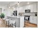 Modern kitchen with stainless steel appliances and island with seating for three at 1575 W 68Th Ave, Denver, CO 80221