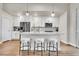 Kitchen with white cabinets, stainless steel appliances, and breakfast bar at 1575 W 68Th Ave, Denver, CO 80221