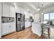 Modern kitchen with stainless steel appliances and island with seating at 1575 W 68Th Ave, Denver, CO 80221