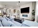 Comfortable living room featuring a sleek fireplace, large TV, and stylish furnishings at 1575 W 68Th Ave, Denver, CO 80221